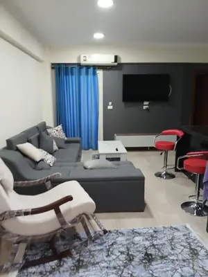 a living room with a couch and a flat screen tv at Princess resort in Hurghada