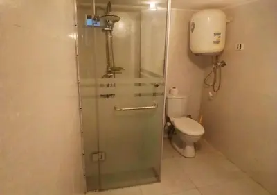 a bathroom with a shower and a toilet at Cozy 1BR Pool View Apartment Steps from the Beach in Hurghada