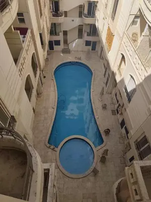 an overhead view of a swimming pool in a building at Paradise Vibe Apartment in Hurghada