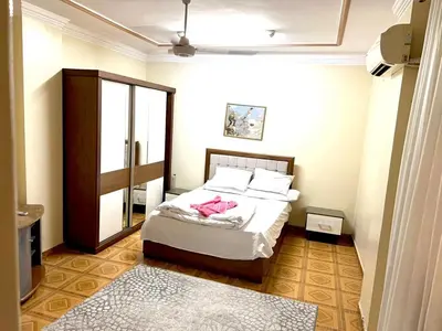 a bedroom with a bed with a pink robe on it at Moon shadow in Luxor