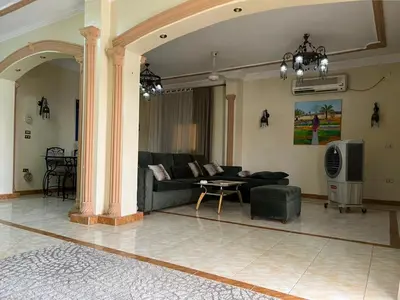 a living room with a couch and a table at Moon shadow in Luxor