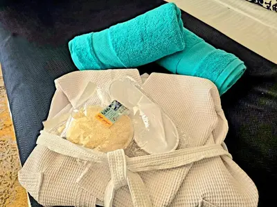 a white bag with a bottle and some towels at The White Lions Villa in Hurghada