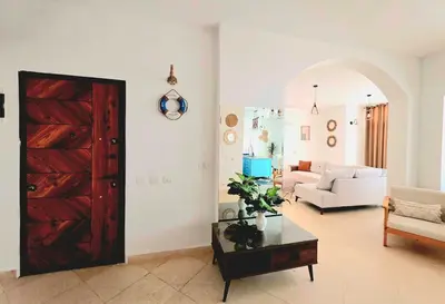 a living room with a wooden door and a couch at The White Lions Villa in Hurghada