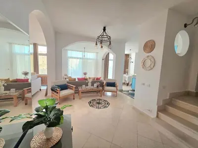 a living room with a couch and a table at The White Lions Villa in Hurghada