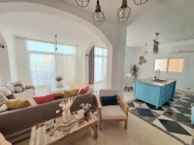 a living room with a couch and a table at The White Lions Villa in Hurghada
