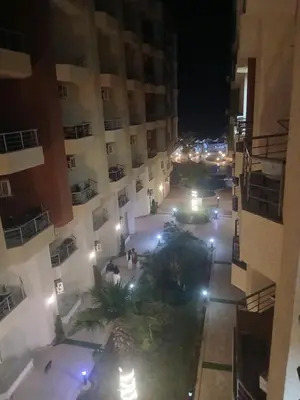 an aerial view of a courtyard at night at كذا بلانكا بيتش417 in Hurghada