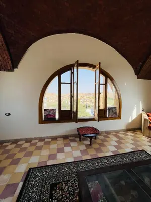 a room with two large windows and a checkered floor at ايـو كـاتو in Jazīrat ‘Awwāḑ