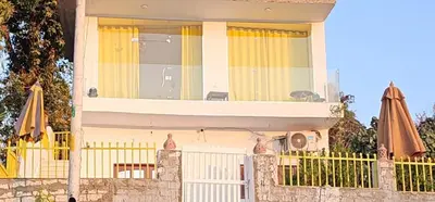 a house with two umbrellas on a balcony at Esmerada in Aswan