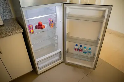 a refrigerator with its door open in a kitchen at Nayah Stays, Joubal Lagoons Terrace in Hurghada