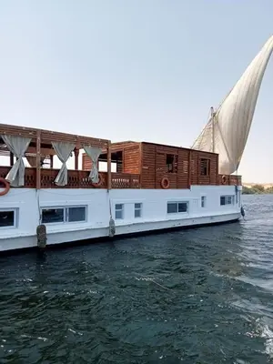 a white boat is sitting in the water at Dahabiya Nile Cruise in Luxor