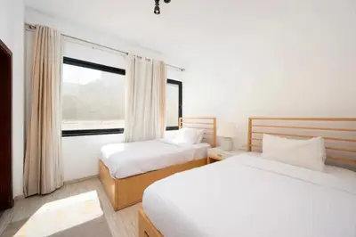 two beds in a room with a window at Luxury Stays in Wadi Jebal Soma Bay in Hurghada