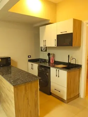 a kitchen with a sink and a stove top oven at Karma Aqua Beach in Hurghada