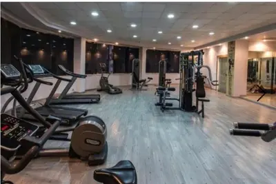 a gym with a bunch of exercise equipment in a room at Karma Aqua Beach in Hurghada