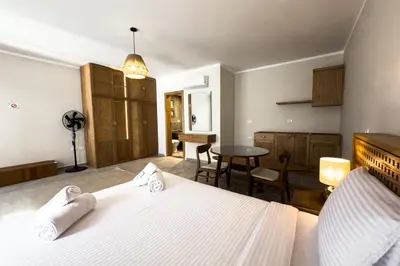 a bedroom with a bed and a table and chairs at Elegance Serene 3 BDR Townhouse w Private Pool Bali Gouna in Hurghada
