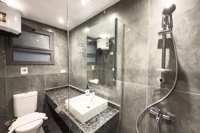 a bathroom with a toilet and a sink and a shower at Elegance Serene 3 BDR Townhouse w Private Pool Bali Gouna in Hurghada