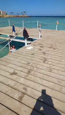 a shadow of a person standing on a dock at Studio Apartment Flourenza Hurghada in Hurghada