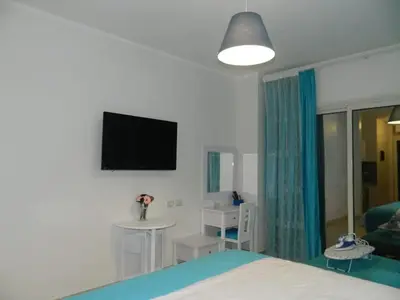 a bedroom with a bed and a tv on the wall at Florenza Khamsin Nor in Hurghada