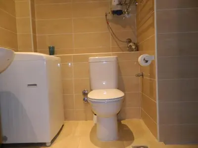 a bathroom with a white toilet and a shower at Florenza Khamsin Nor in Hurghada