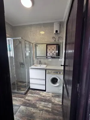 a bathroom with a washing machine and a sink at Stella Makadi Bay - Balcony Apartment near Pool & Beach - Holiday Makadi in Hurghada