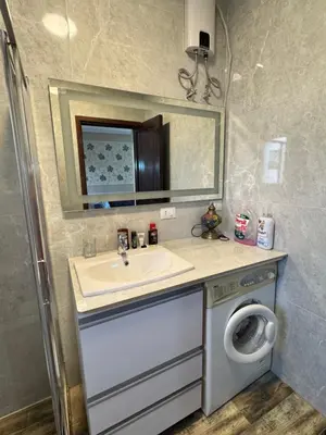 a bathroom with a sink and a washing machine at Stella Makadi Bay - Balcony Apartment near Pool & Beach - Holiday Makadi in Hurghada