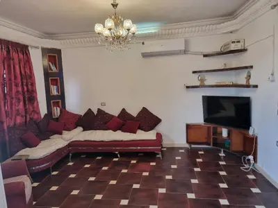 a living room with a couch and a flat screen tv at Adream partment in Luxor in Luxor