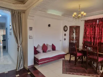 a living room with a couch and a dining room table at Adream partment in Luxor in Luxor