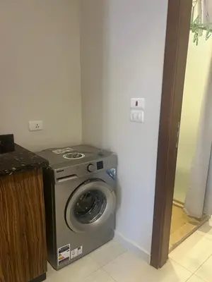 a washer and dryer in a corner of a room at La Blanca in Hurghada