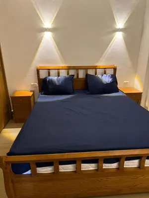 a bedroom with a wooden bed with blue pillows at Red Sea Horizon in Hurghada