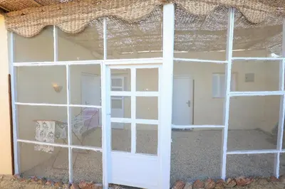 a room with a window with a white ladder at Tohamy house in Al Aqālitah