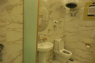 a bathroom with a white toilet and a sink at Crystala 2 guest house in Aswan