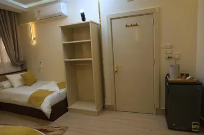 a small bedroom with a bed and a closet at Crystala 2 guest house in Aswan