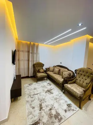 a living room with two couches and a tv at Modern place Hurghada in Hurghada