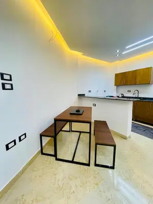 a living room with a table and a counter at Modern place Hurghada in Hurghada