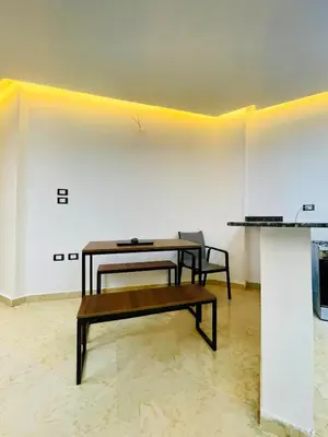 a table and a bench in a room at Modern place Hurghada in Hurghada