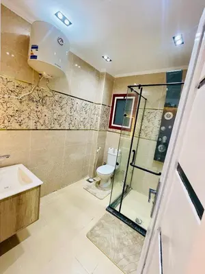 a bathroom with a shower and a toilet and a sink at Modern place Hurghada in Hurghada
