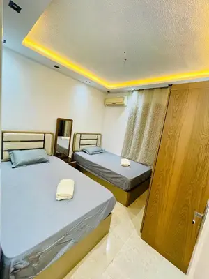 a bedroom with two beds and a window at Modern place Hurghada in Hurghada