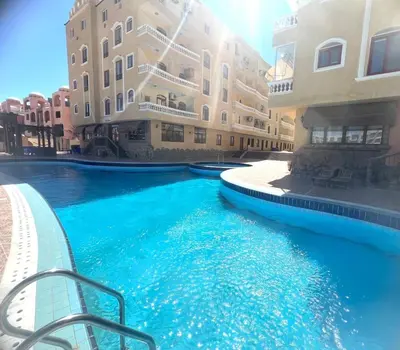 a swimming pool in the middle of a building with blue water at Modern place Hurghada in Hurghada