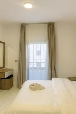 a bedroom with a large white bed and a window at Hurghada concierge at La Prestigia B2 4 in Hurghada