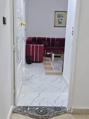 a hallway with a living room with a couch at Hatshepsut Apartments Luxor in Luxor