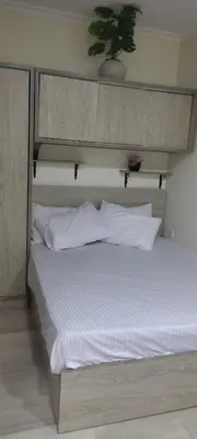 a bed with white sheets and pillows in a room at Princess resort217 in Hurghada