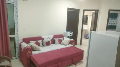 a living room with a red couch with pillows at Elite House in Hurghada