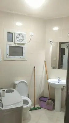 a bathroom with a toilet and a sink at Elite House in Hurghada