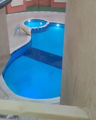 a swimming pool with blue lighting in a building at Elite House in Hurghada
