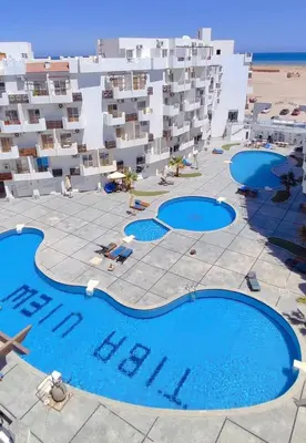 an aerial view of a hotel with two swimming pools at Al Mutamayz Tiba in Hurghada