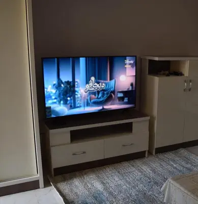 a flat screen tv sitting on top of a dresser at Al Mutamayz Tiba in Hurghada