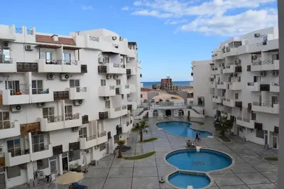 an aerial view of a building with two pools at Al Mutamayz Tiba in Hurghada