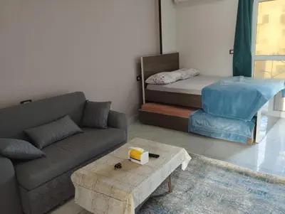 a living room with a couch and a bed at Al Mutamayz Tiba in Hurghada