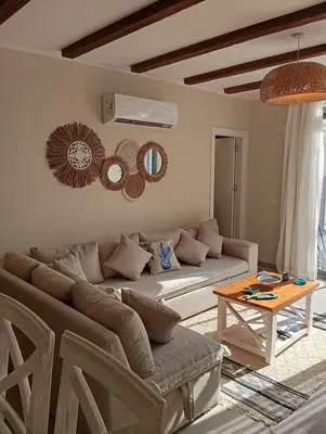 a living room with a couch and a table at Bali 2 bed with private pool in Hurghada