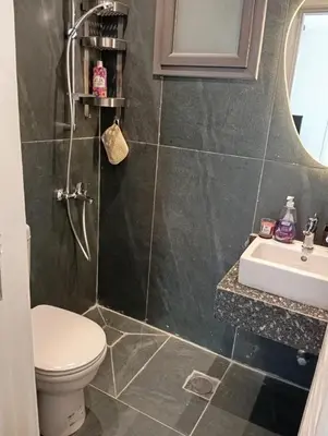 a bathroom with a toilet and a sink at Bali 2 bed with private pool in Hurghada