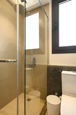 a bathroom with a glass shower and a toilet at Stunning 3 bd penthouse with private pool - El Gouna in El Gouna